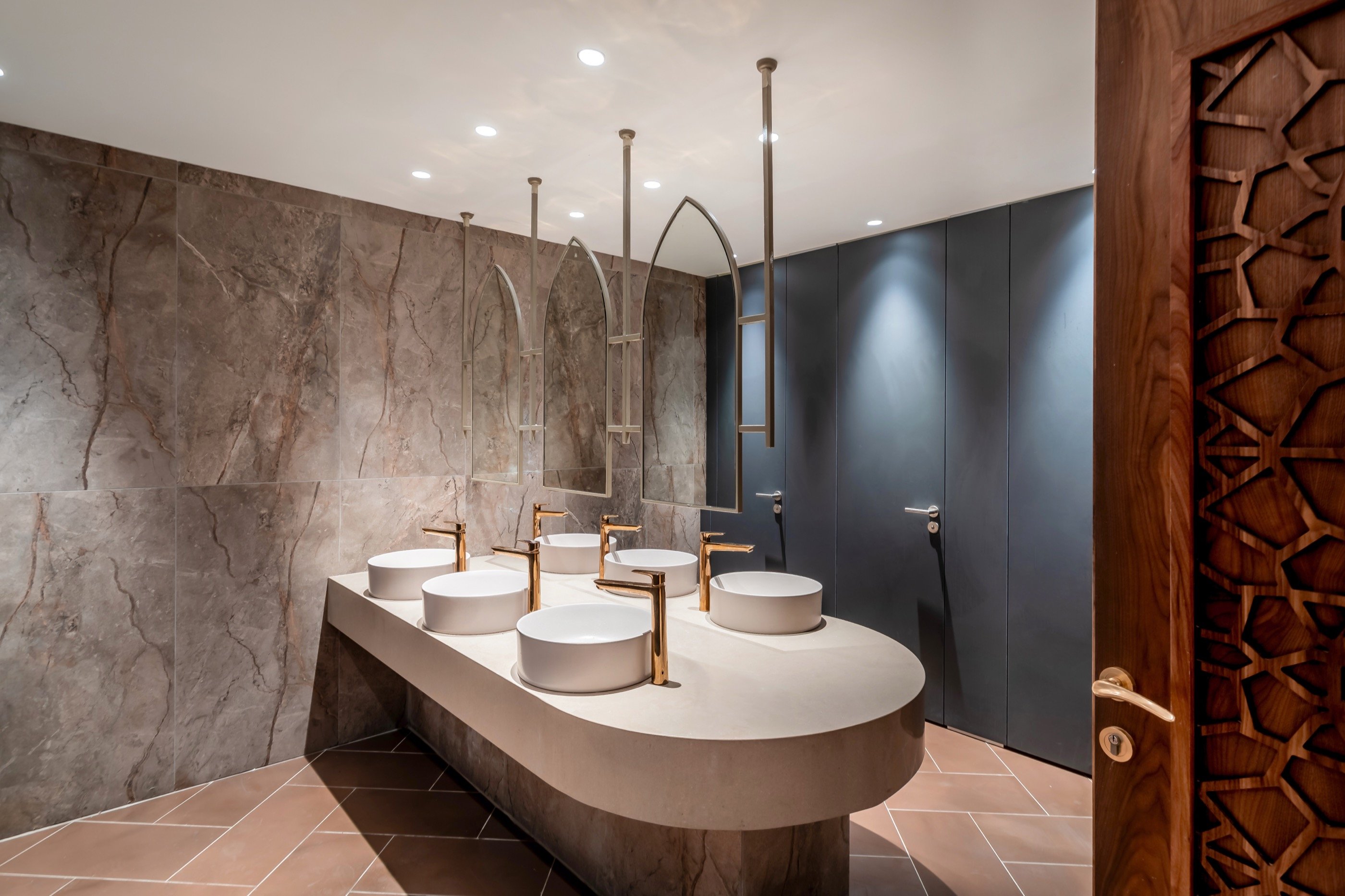 Stone and brass — the washroom detail.