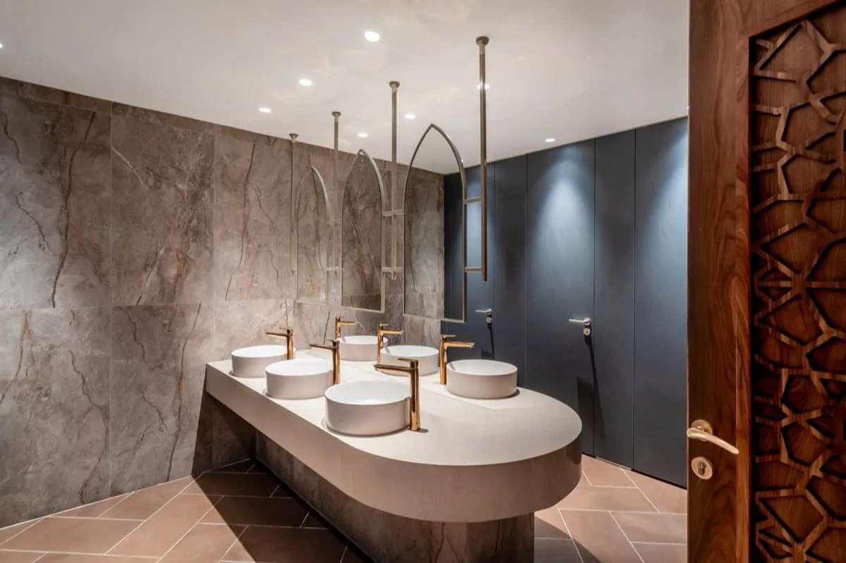 Stone and brass — the washroom detail.