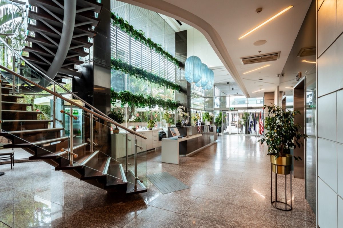 The lobby — marble, greenery, blue light.