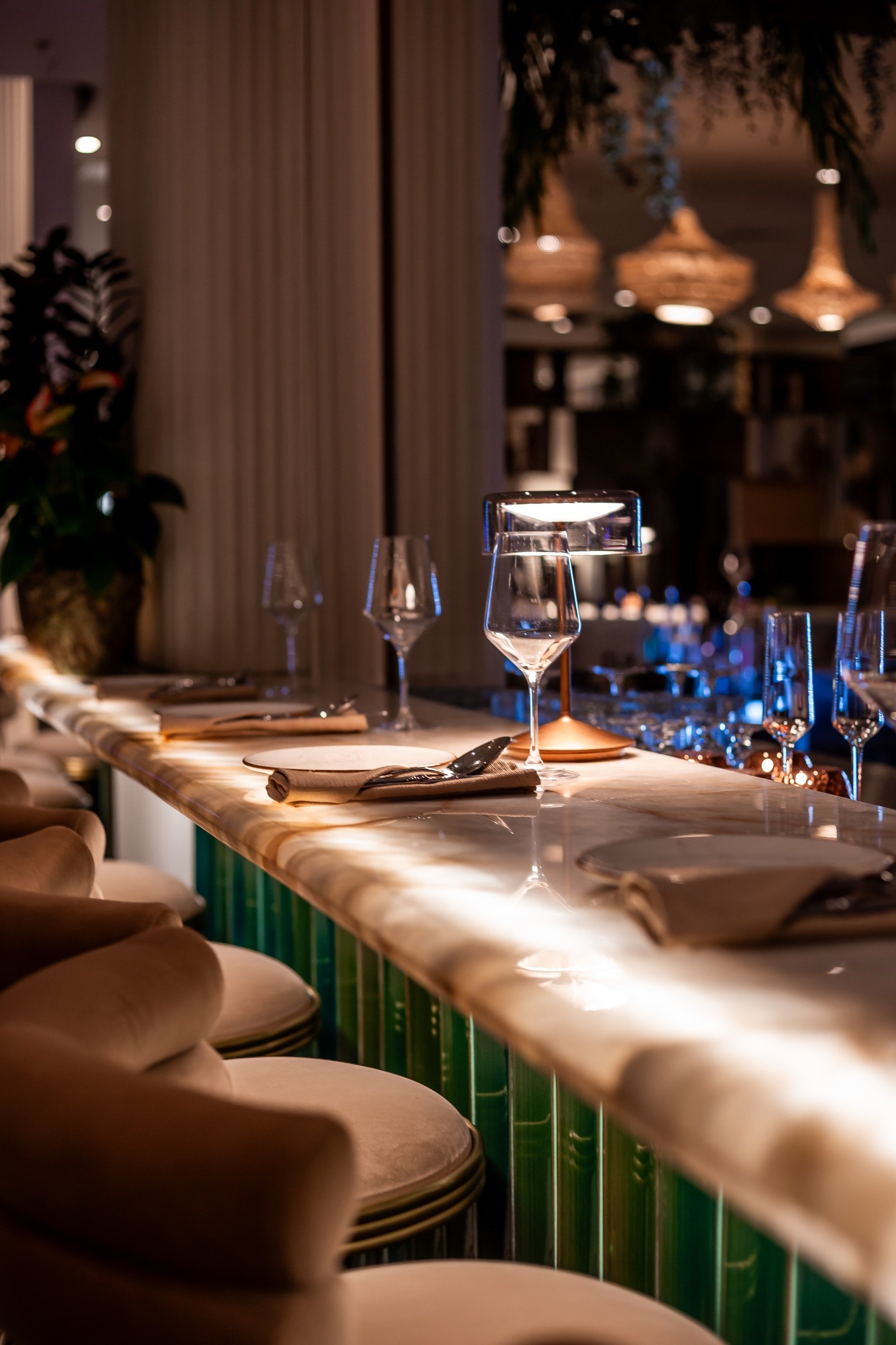 Marble, brass, a single light over the bar.
