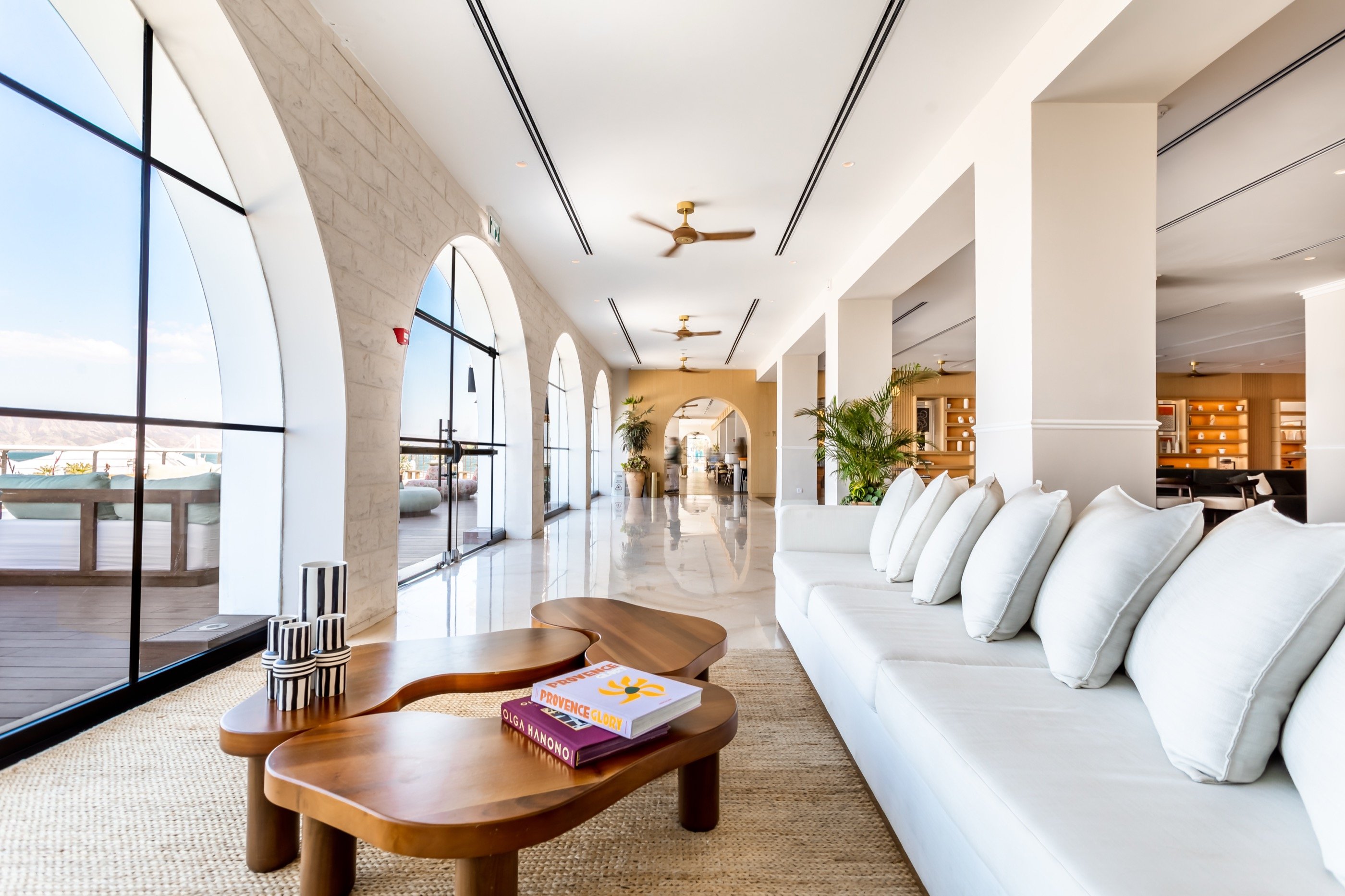 Corridor — white cushions and a kept-open view.