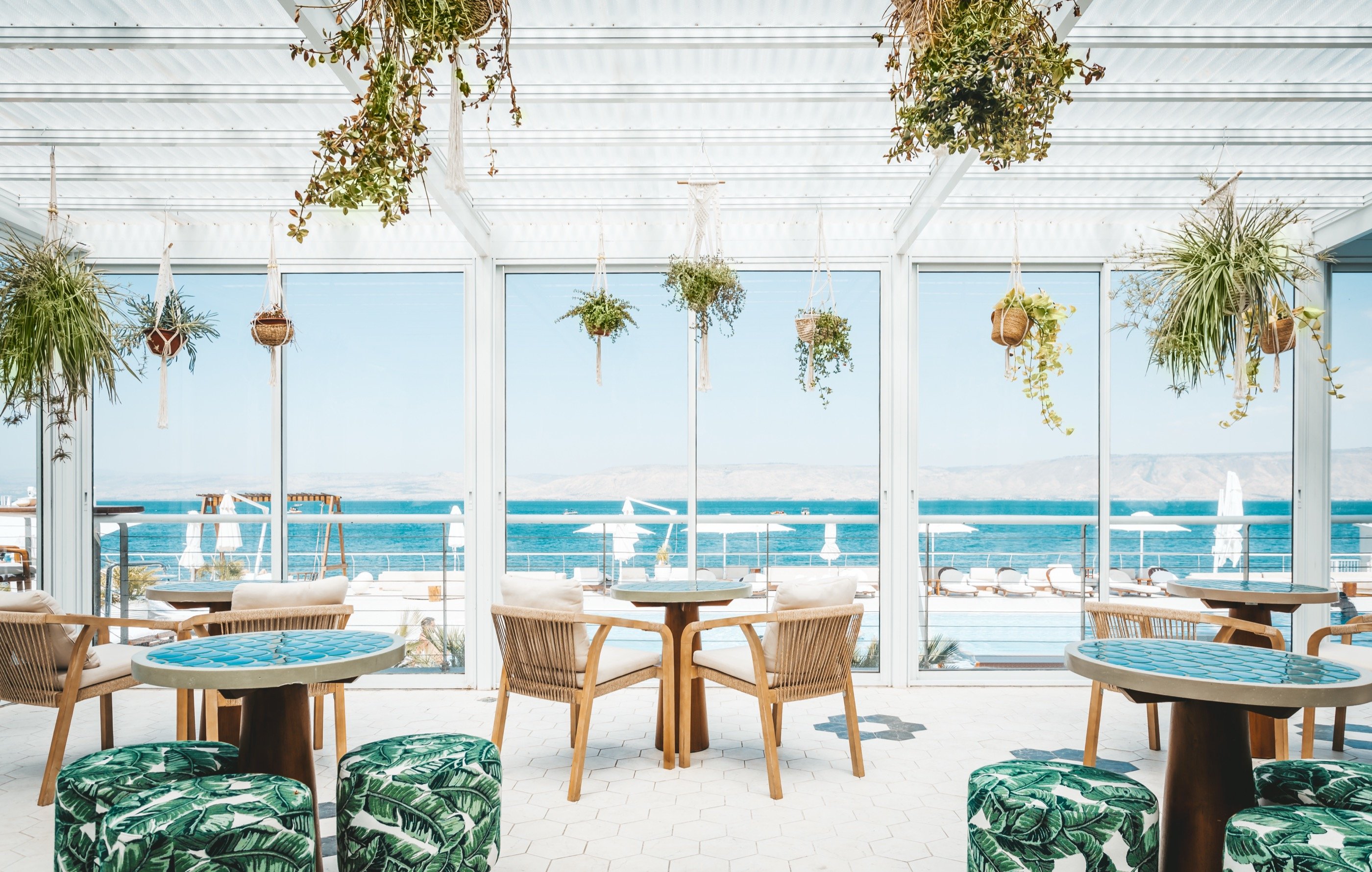 Beach bar — glass, plants, the lake.