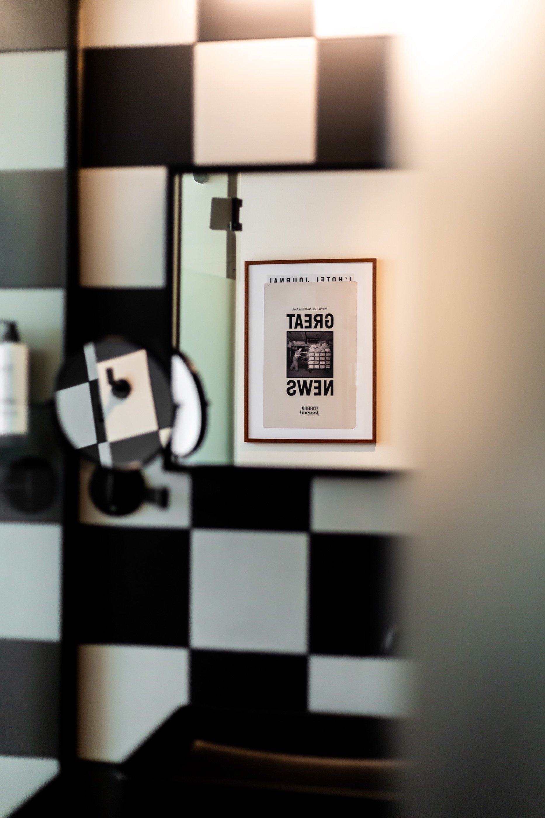 Tile, mirror, the bathroom's single poster.