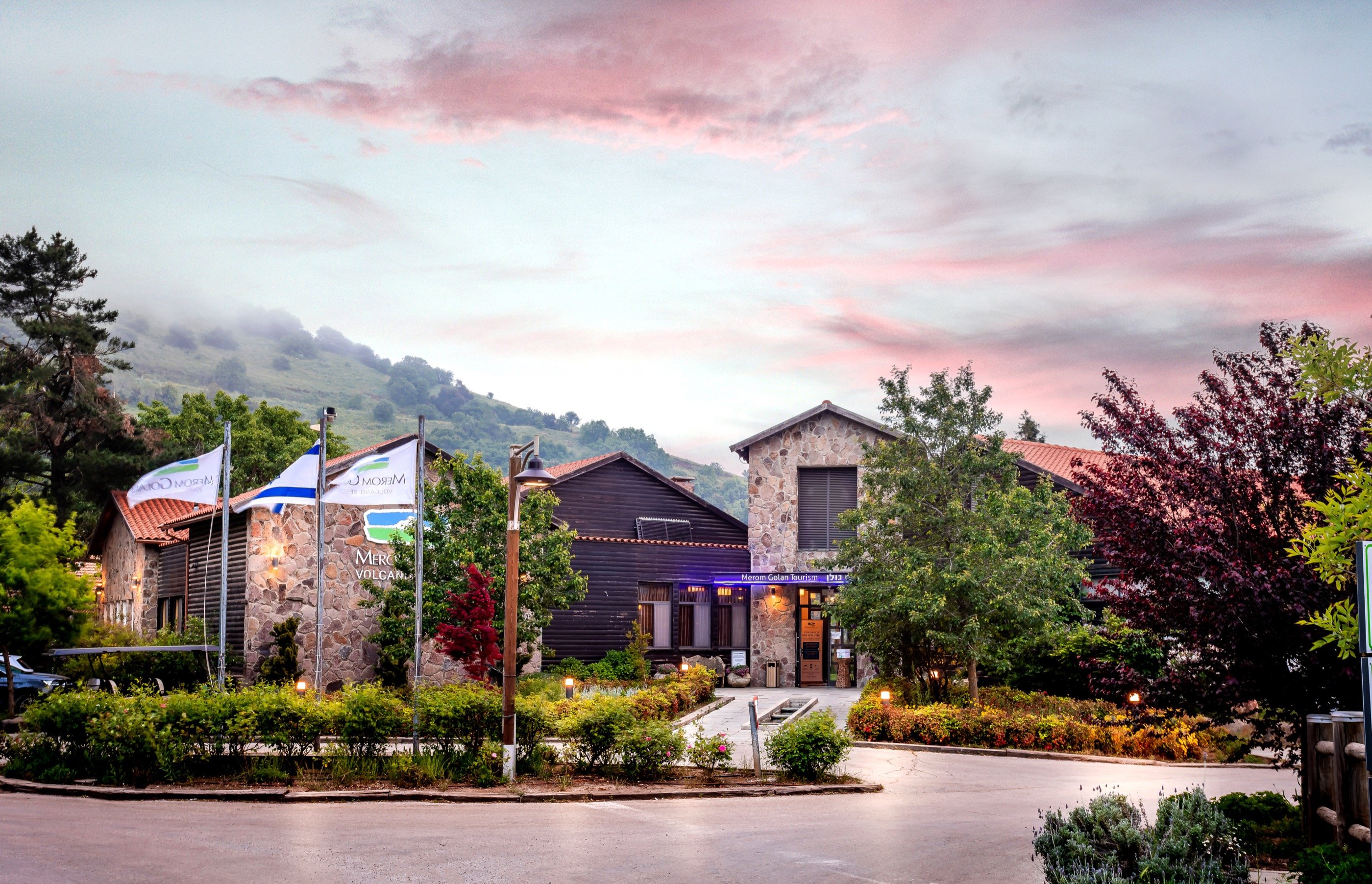 The entrance, the flags, a Galilean pink sky.