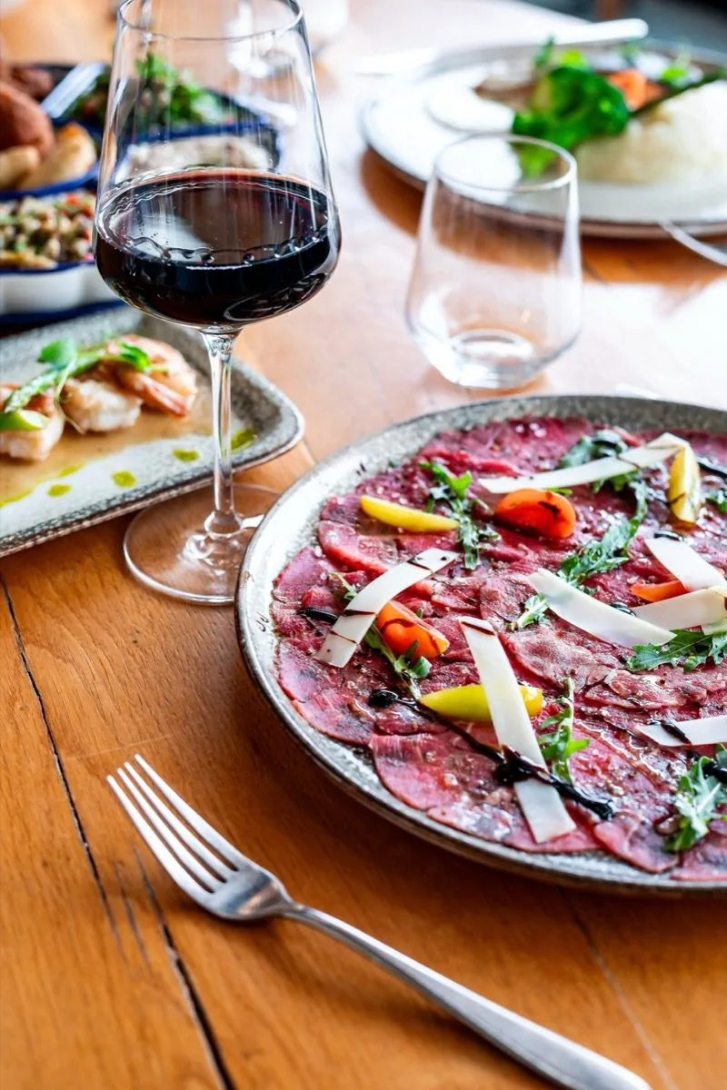 Wine, carpaccio, late light.