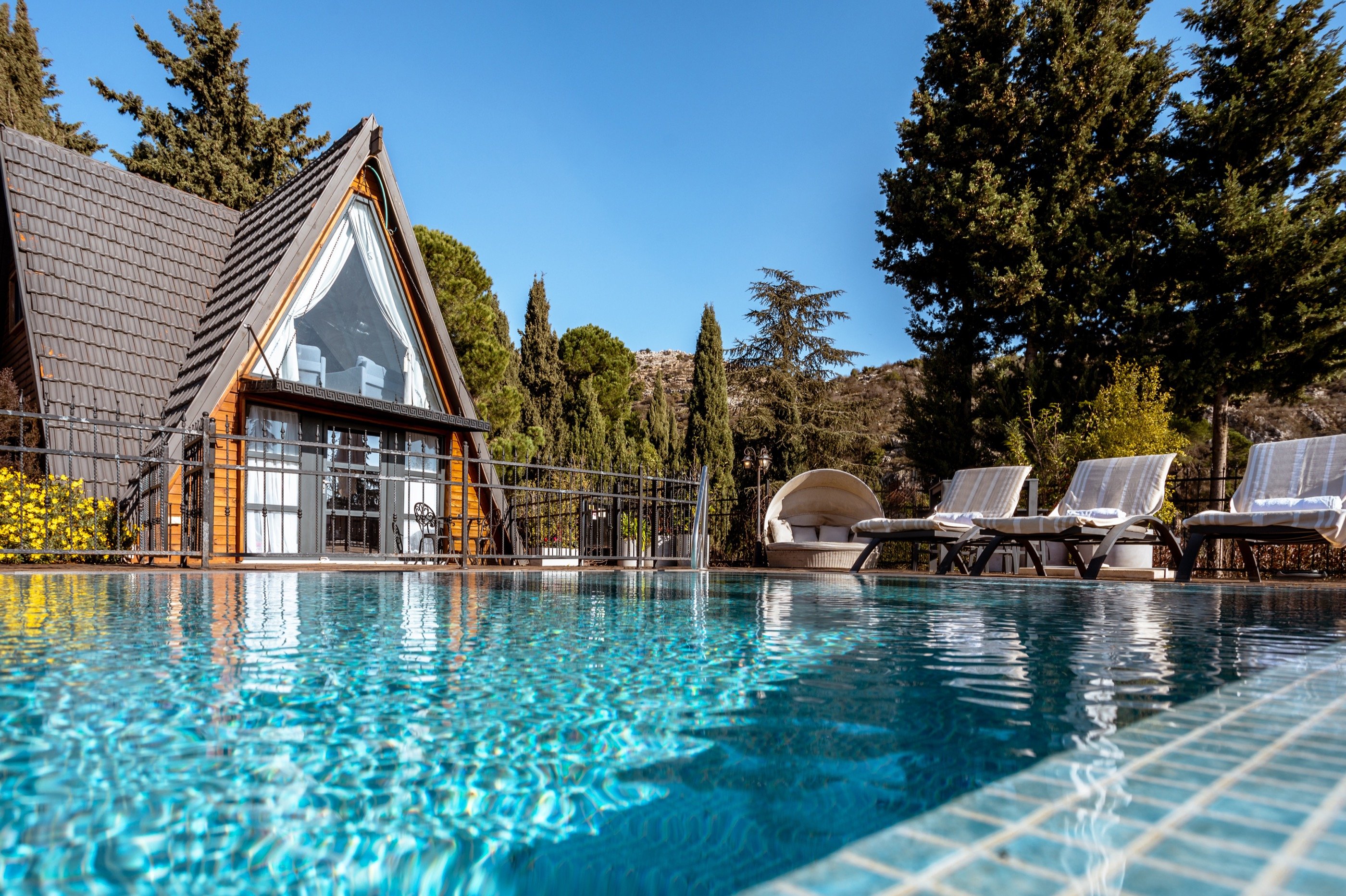 A cabin reflected in its own pool.