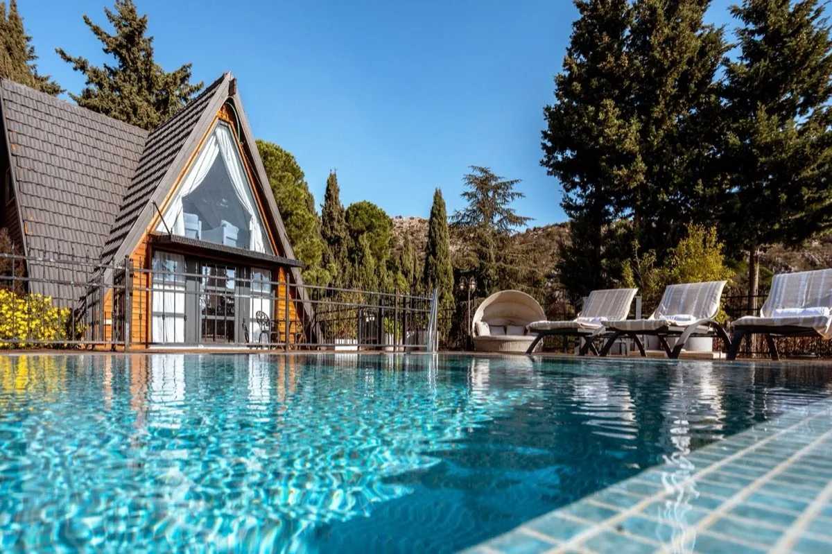 A cabin reflected in its own pool.