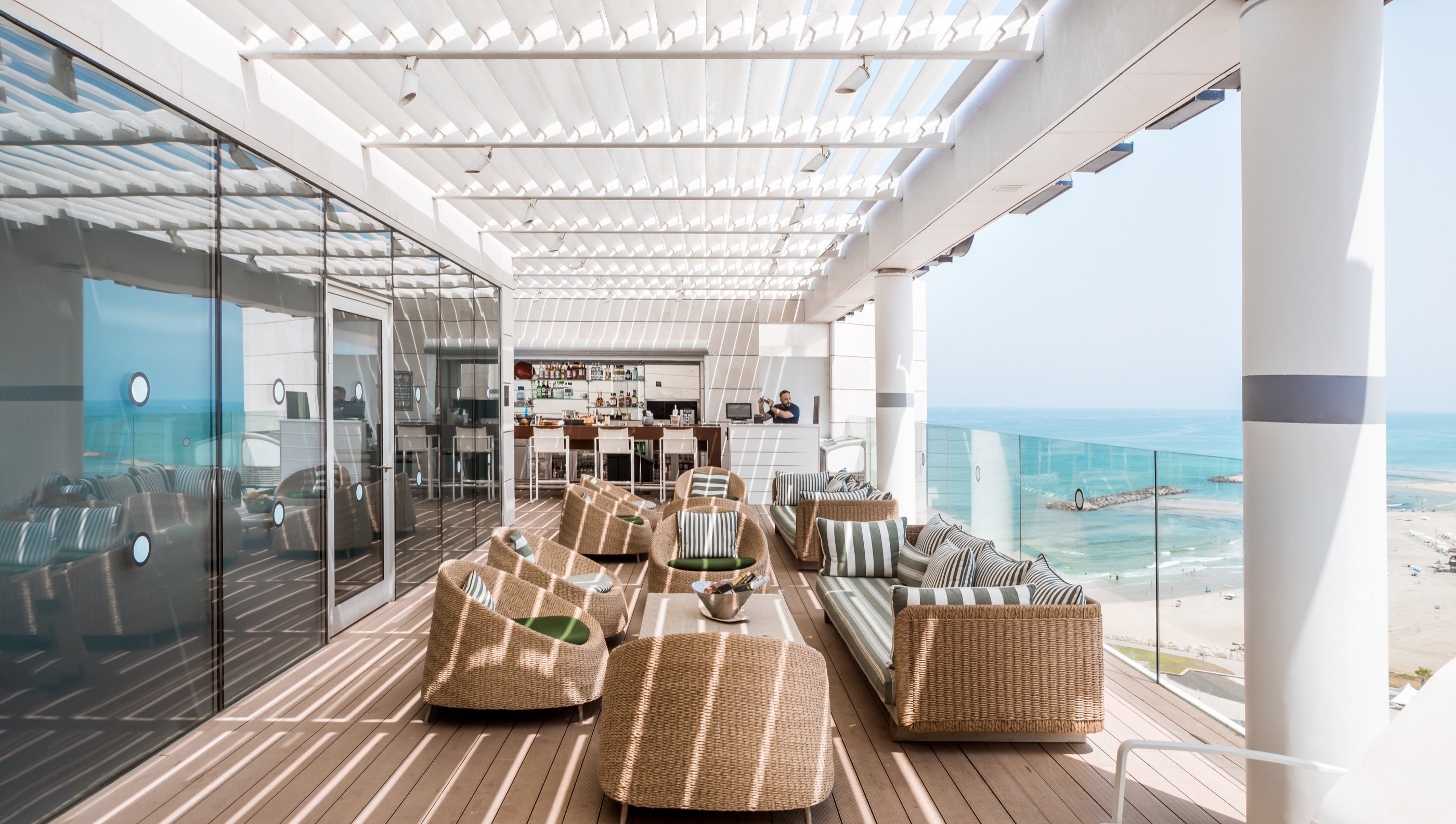 Rooftop lounge — wicker and a long horizon.