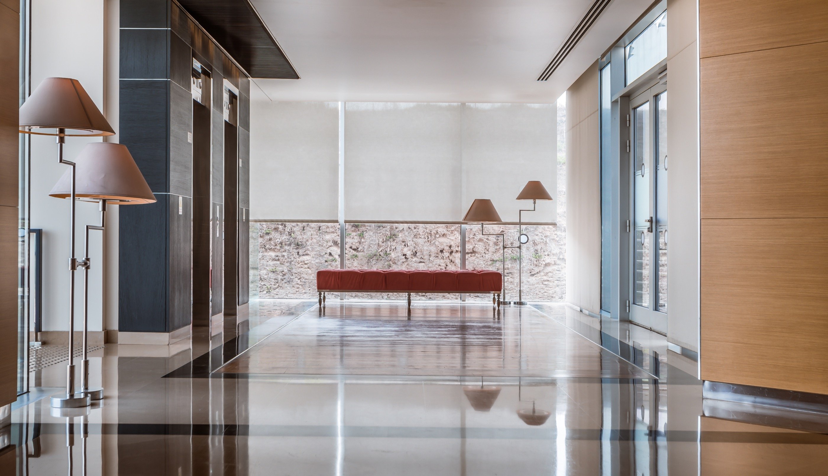 The arrival lobby — still water, warm light.