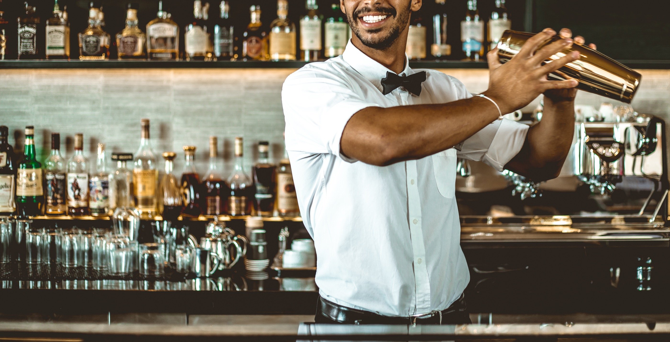 The bartender, mid-motion.