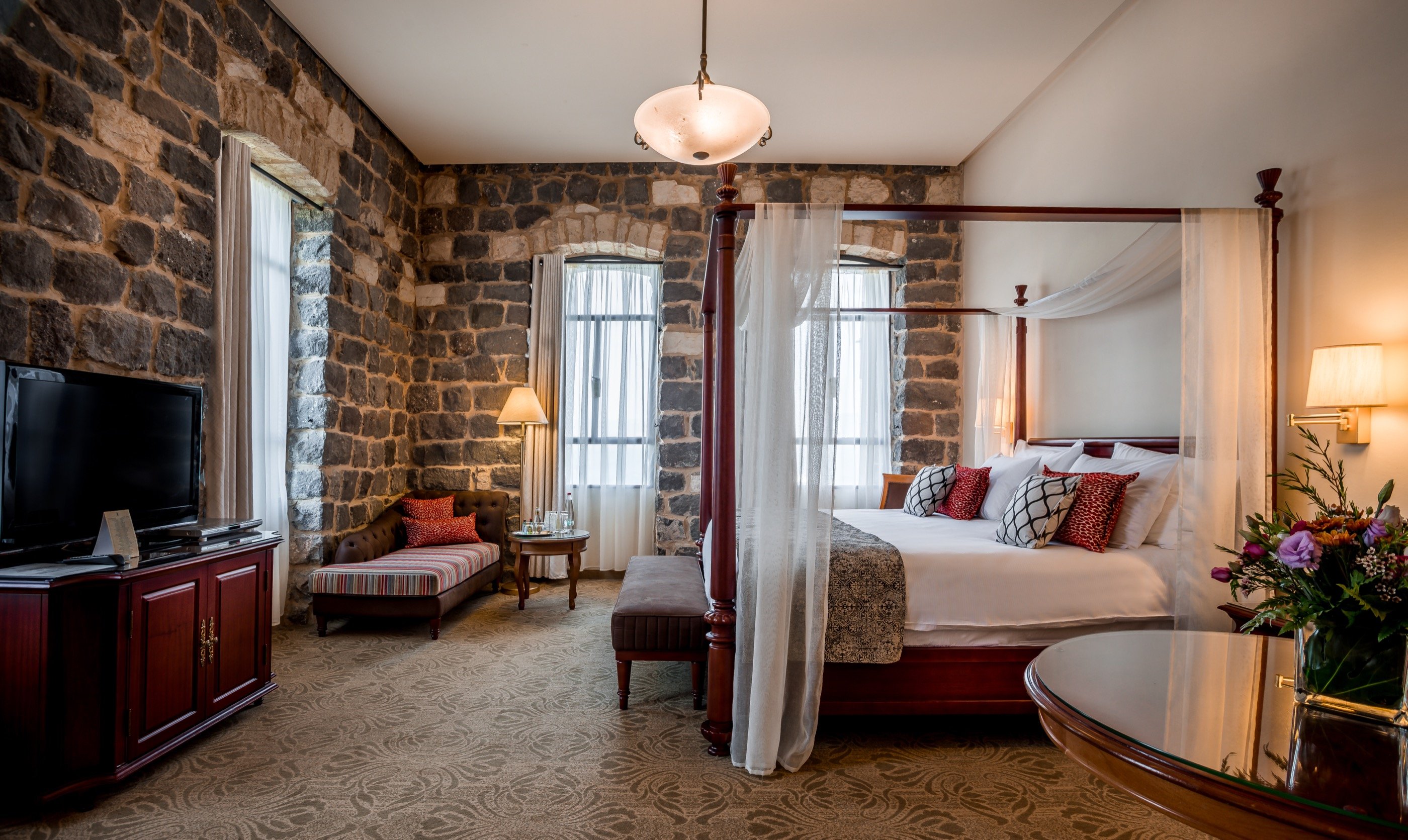 The four-poster, the stone wall — a suite with memory.